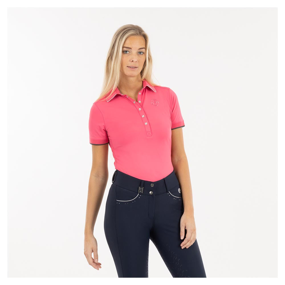 Woman modeling pink ANKY polo shirt and dark riding breeches.