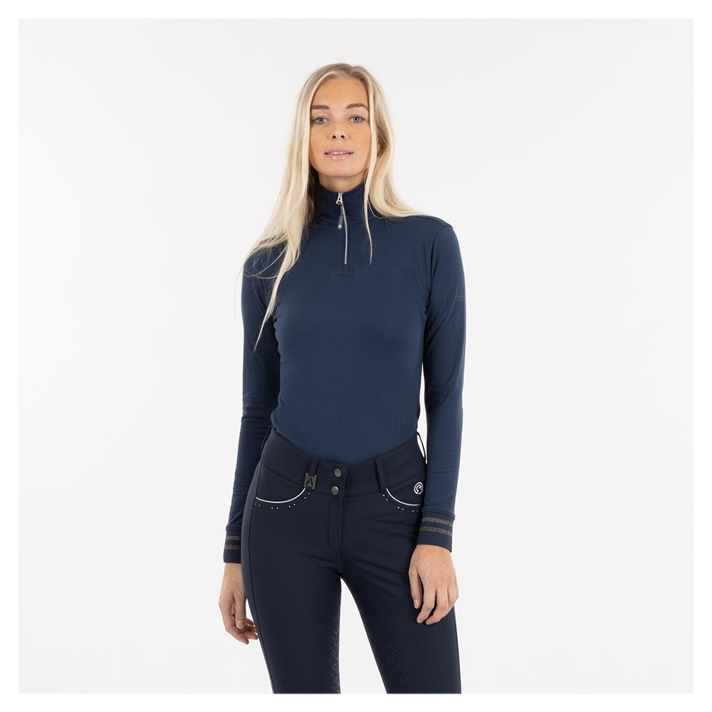 Woman in ANKY navy blue equestrian sportswear top and breeches.