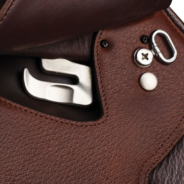 Close-up of Arena Saddles brown leather saddle detail with metal accents.