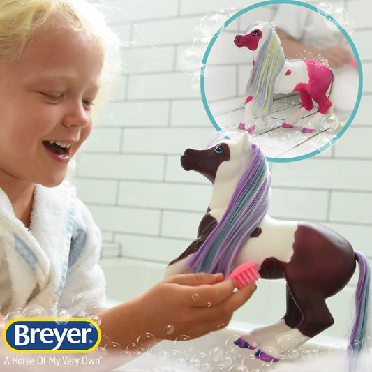 Child playing with Breyer Horse Toy, colorful mane, bath, bubble overlay.