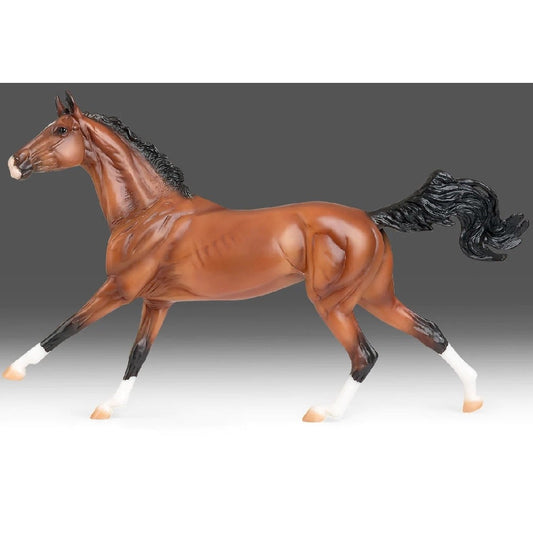 Breyer Horse Toys plastic model of a chestnut horse on gray background.