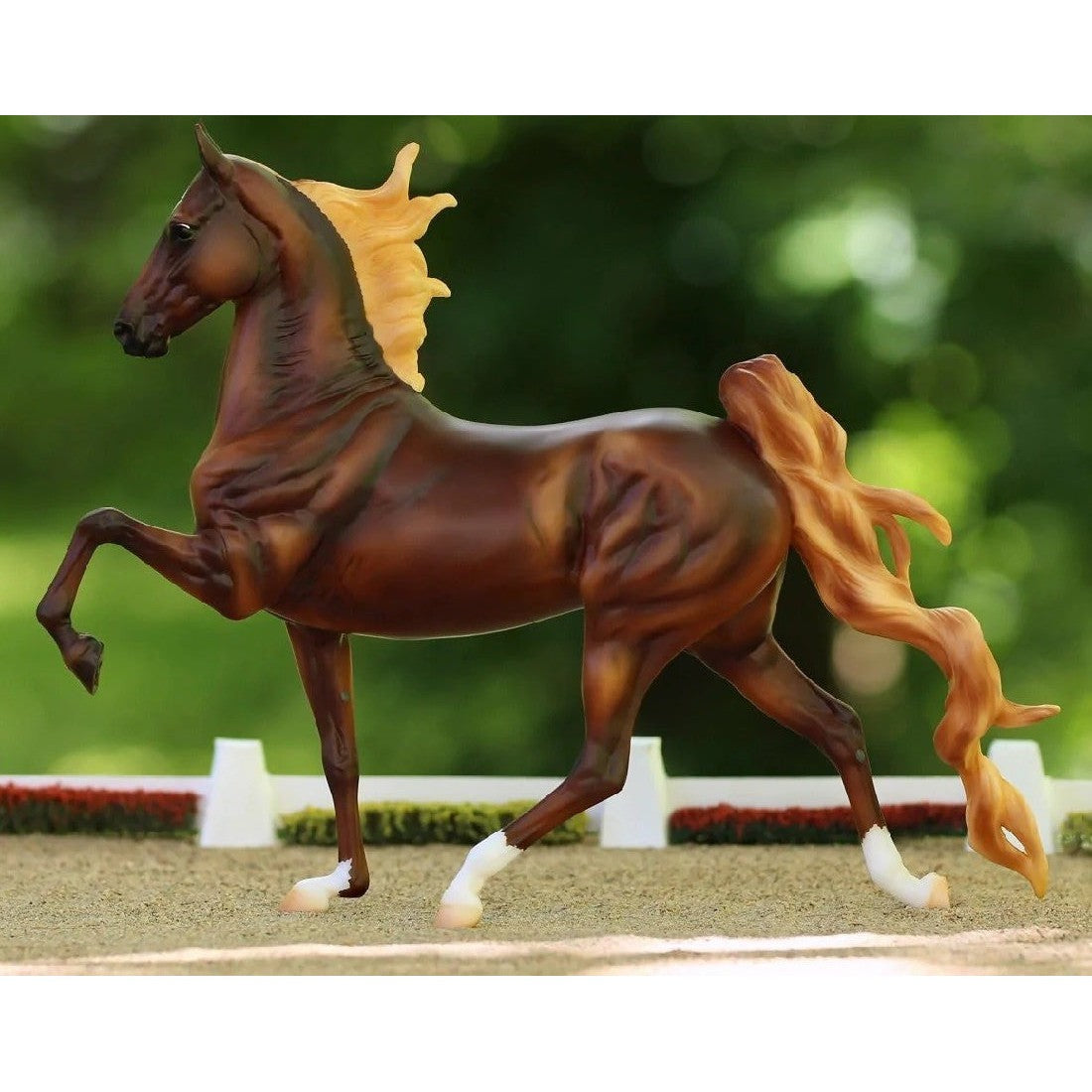 Breyer Horse Toys model with chestnut coat, prancing pose, on grass.