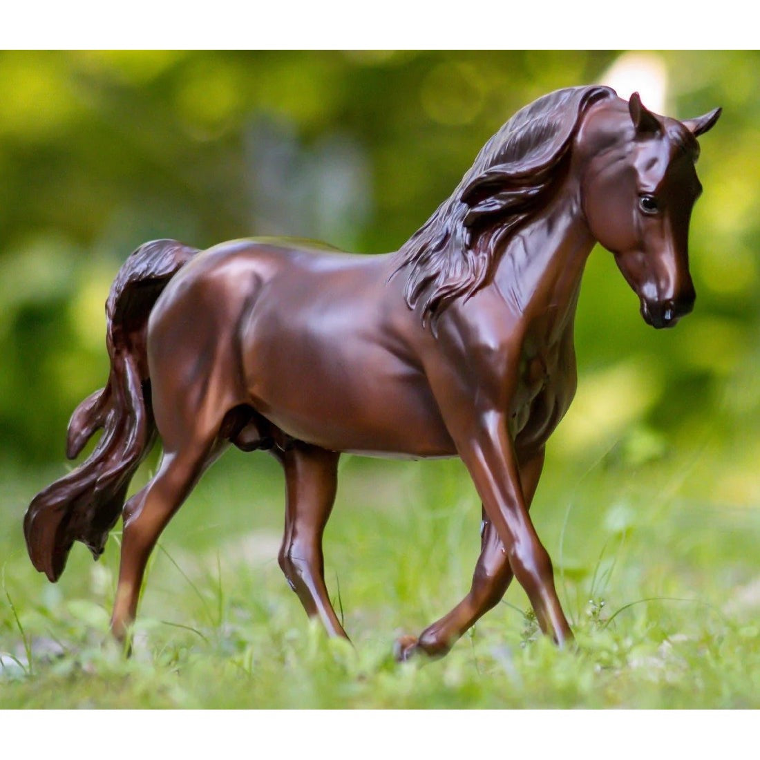 Breyer Horse Toys model of a brown horse on green grass.