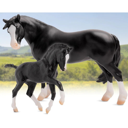 Breyer Horse Toys: Adult and foal black horses on grass background.