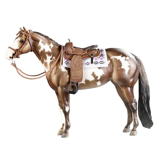 Breyer Horse Toy with brown and white coat and detailed saddle.