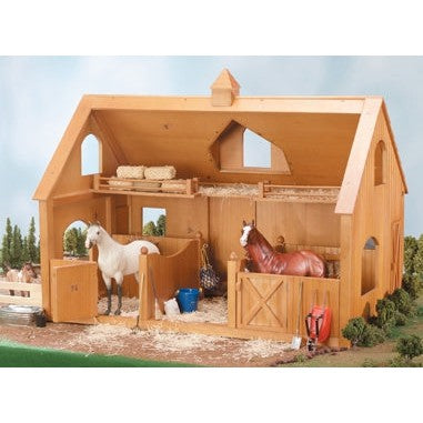 Breyer Horse Toys wooden stable with two model horses inside.
