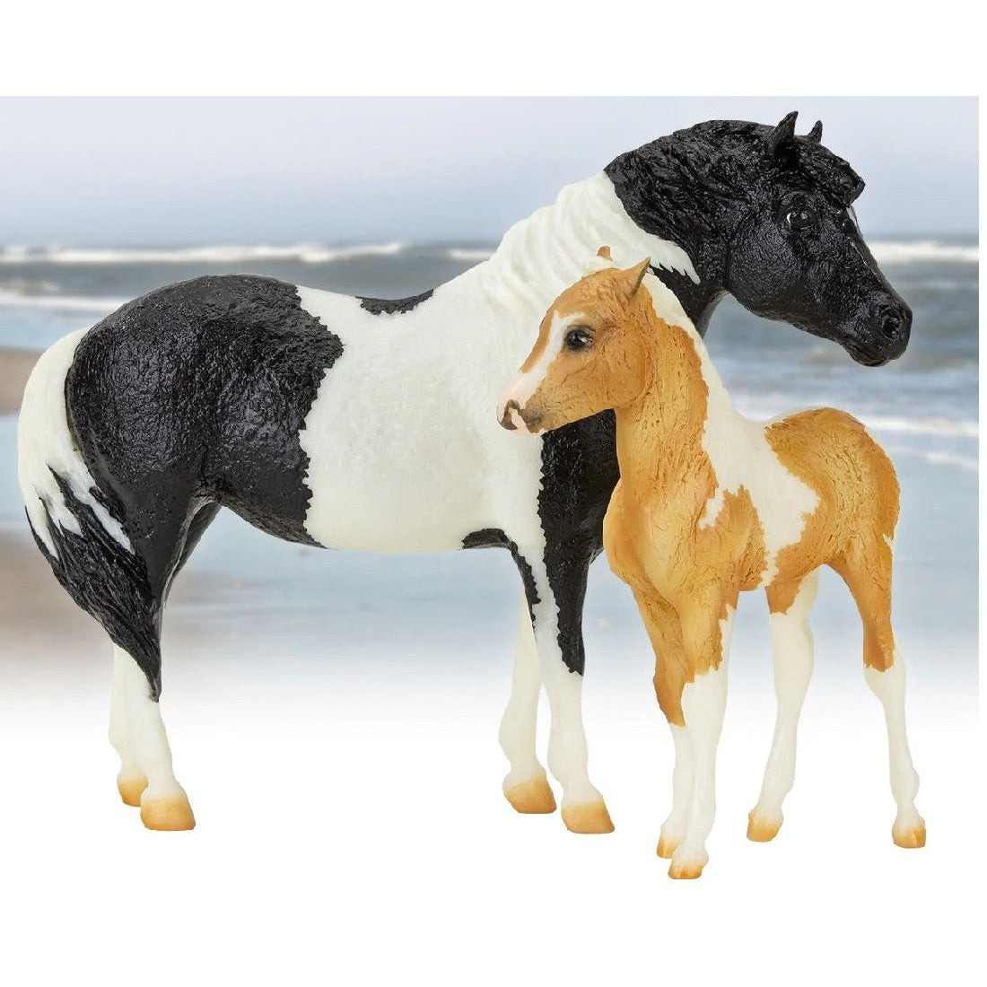 Breyer Horse Toys models of a black and white mare and foal.