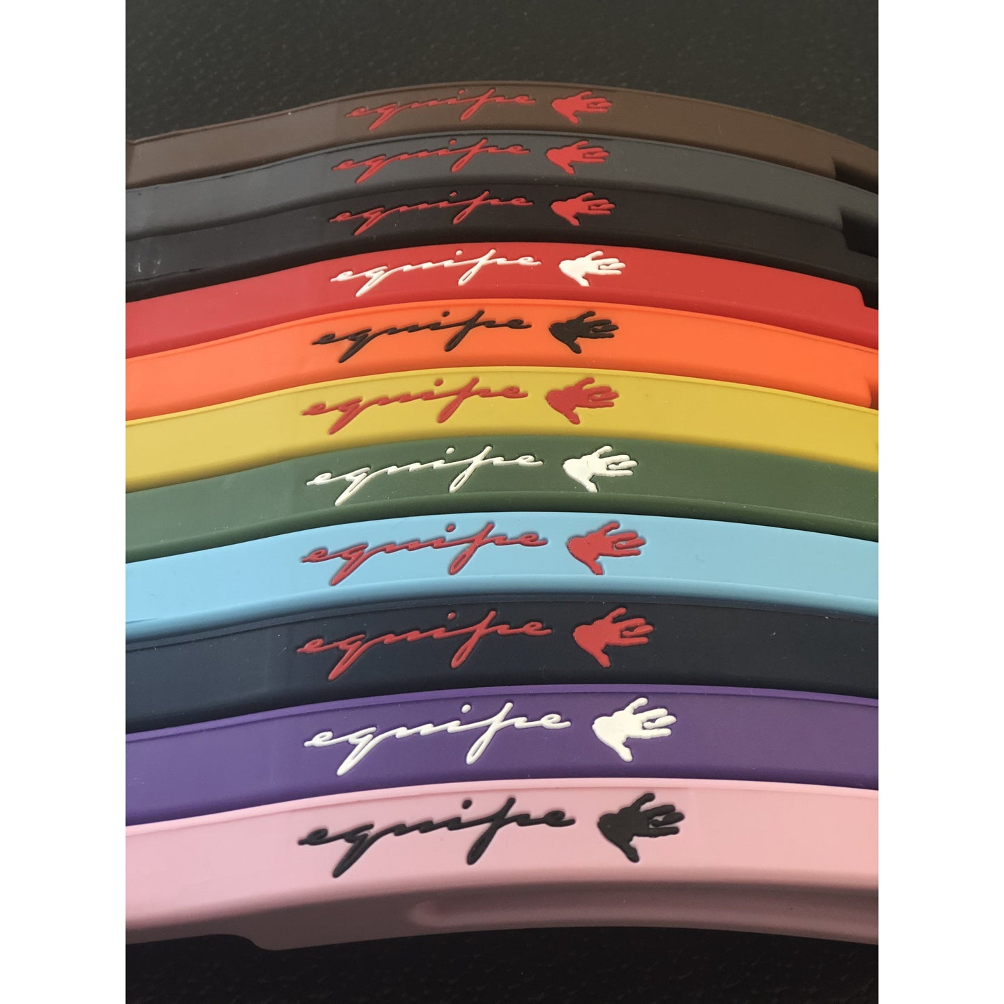 Colorful stirrup leathers stacked with brand logo on top.