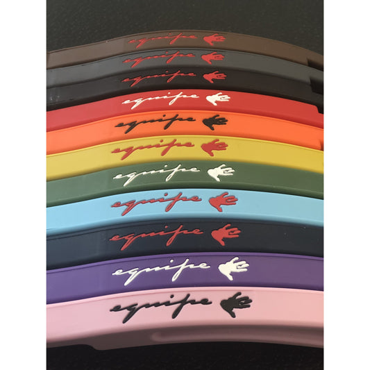 Colorful stirrup leathers stacked with brand logo on top.