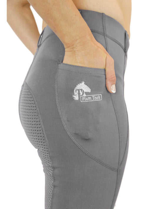 Close-up of gray horse riding tights with mesh detailing and logo.