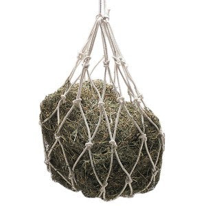 Hanging hay feeder with knotted rope net on a white background.