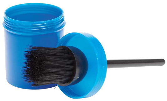 An open blue container with a brush attached to the lid, the brush having black bristles, isolated on a white background.