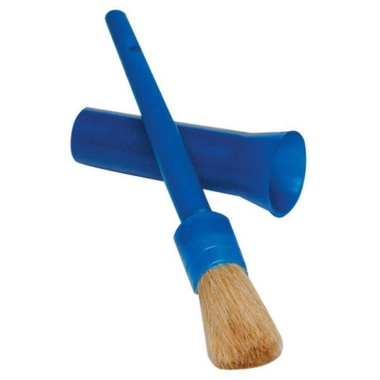 A blue plastic kazoo instrument crossed with a similarly colored makeup brush with a wooden tip and natural bristles, isolated on a white background.