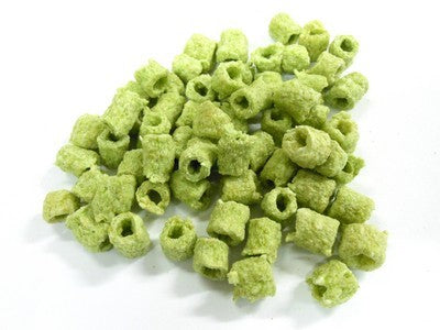 Green cube-shaped horse treat pieces piled on white background.