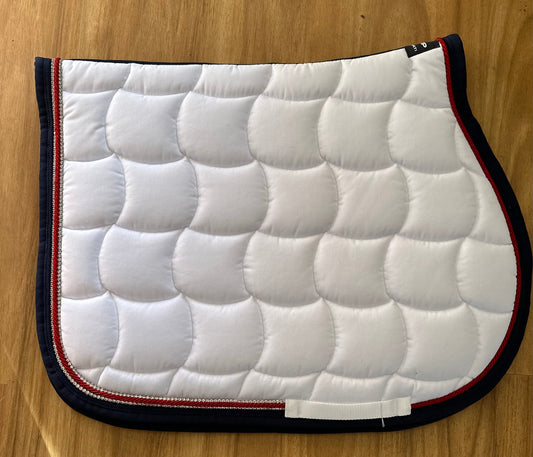 Anna Scarpati white horse saddle pad with red and navy trim.