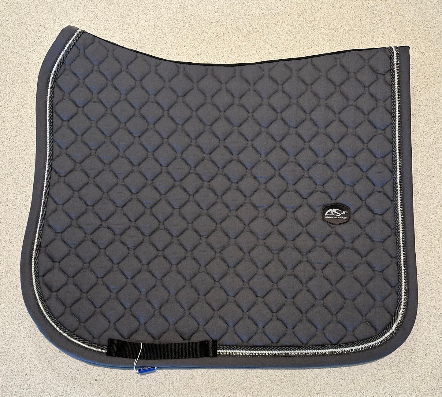 Alt text: Anna Scarpati black horse saddle pad with quilted design.