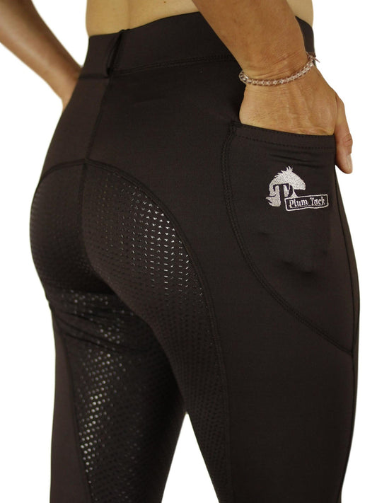 Person wearing black horse riding tights with grip detailing.