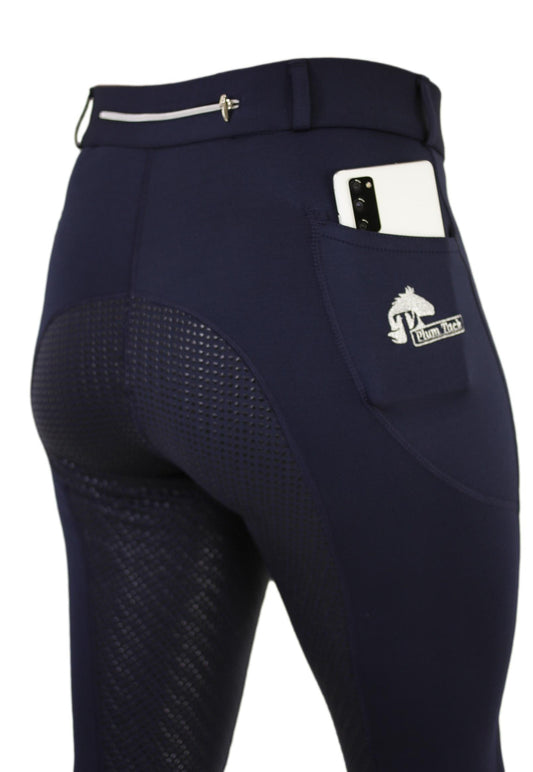 Close-up of navy blue horse riding tights with a phone pocket.