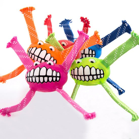 Colorful Rogz Grinz Balls with funky legs on white background.