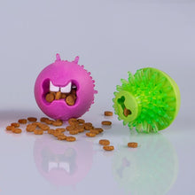 Rogz dog toys and treats on reflective surface.