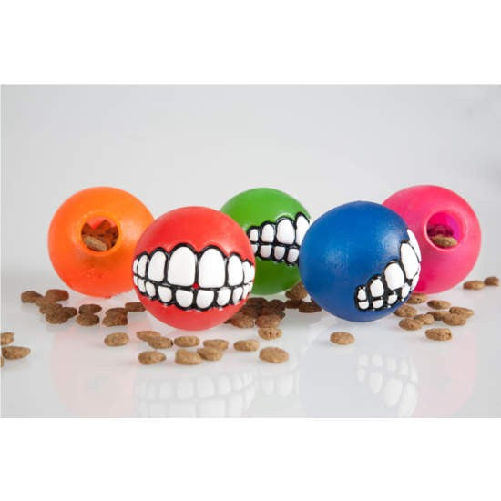 Colorful Rogz dog balls with quirky teeth designs.