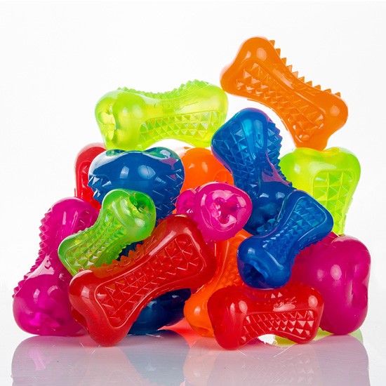 Colorful Rogz dog toys in bone shapes stacked together.