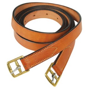 Brown leather stirrup leathers with brass buckles, coiled neatly.