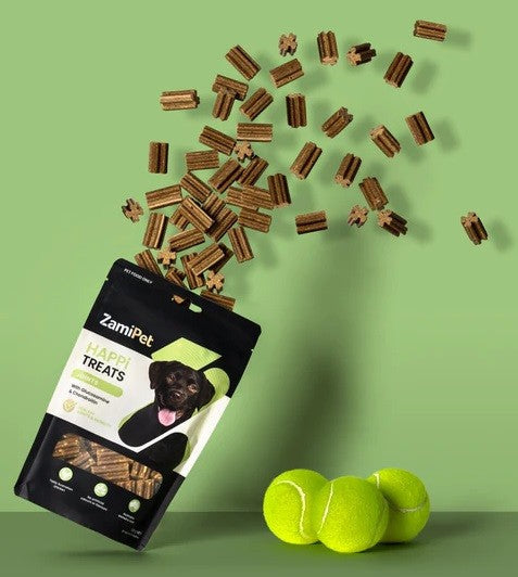 Zamipet Happy Treats dog snack pack spilling over tennis balls.