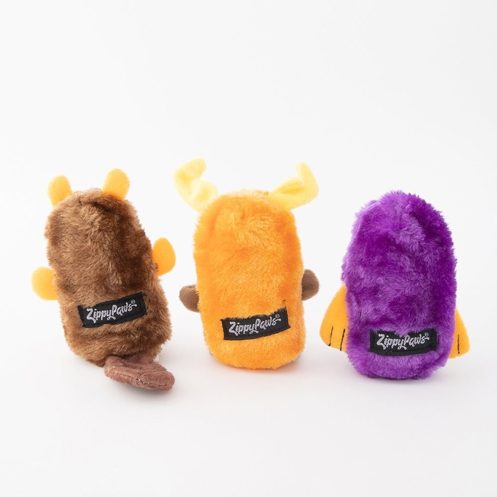 Three Zippy Paws plush dog toys in brown, orange, and purple.