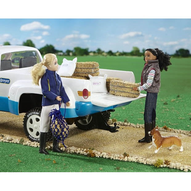 Breyer Horse Toys figures loading hay into a pickup truck.