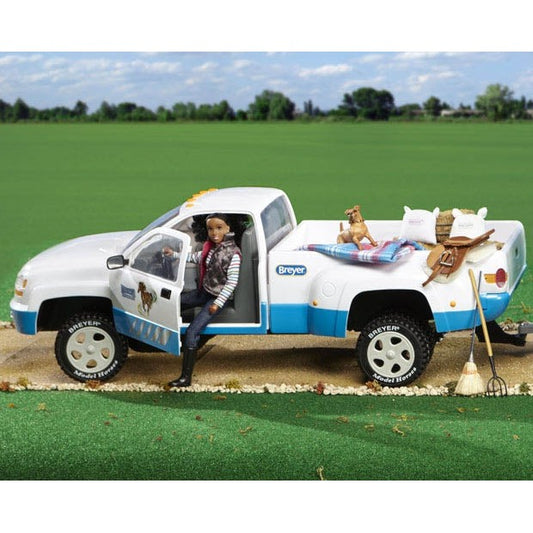 Breyer Horse Toys pickup truck with figurines and accessories on grass.