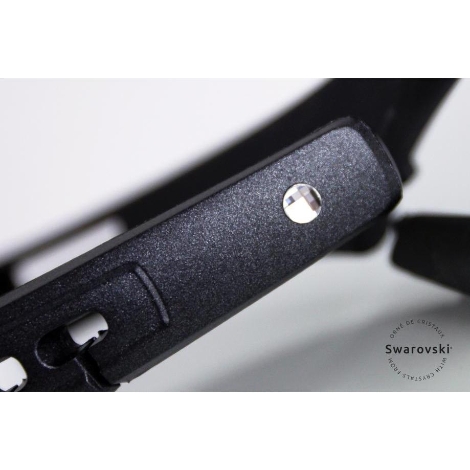 Close-up of black stirrup leathers with a single Swarovski crystal detail.