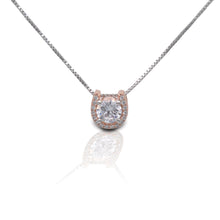 Kelly Herd Jewelry: Rose gold pendant with central diamond on silver chain.