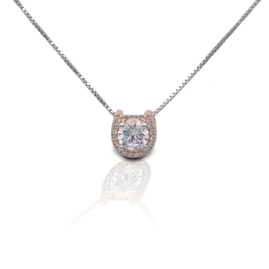 Kelly Herd Jewelry: Rose gold pendant with central diamond on silver chain.