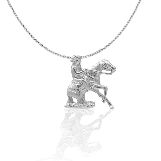 Kelly Herd silver horse and rider pendant necklace on white background.